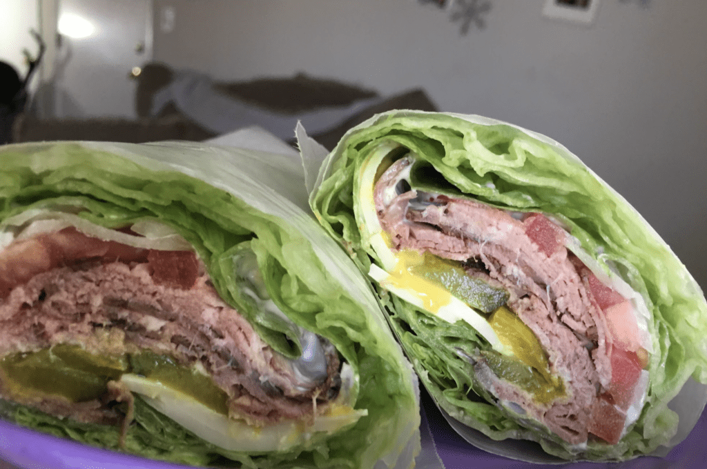 High Protein Homemade Lettuce Wrap Roast Beef Sandwich complete with Wax paper to hold it together
